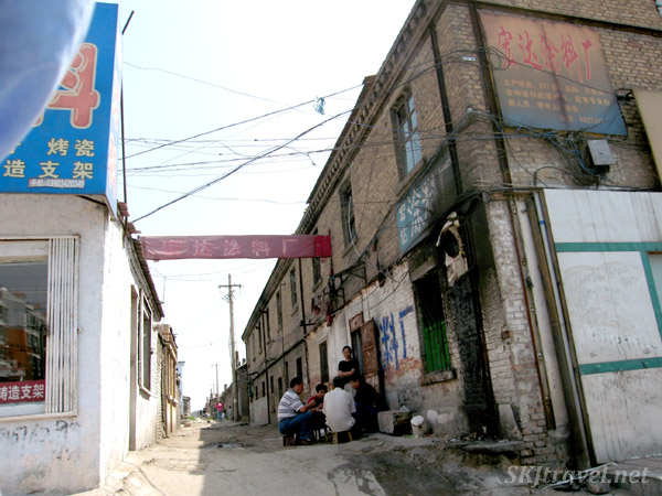 Many old alleys with people playing cards. Datong, China. alleyway with people sitting playing cards
