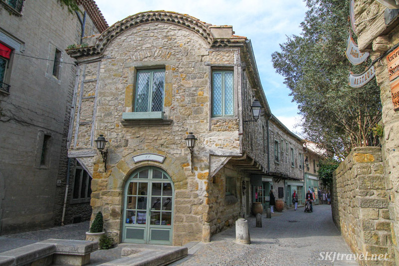 Typical cobblestone street inside the medieval walled city of Carcassonne, France, lined with souvenir shops. Typical cobblestone street inside the medieval walled city of Carcassonne, France, lined with souvenir shops.